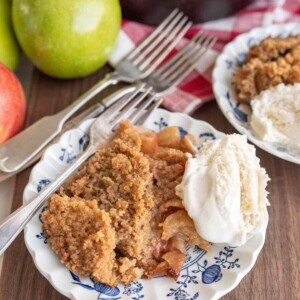 apple crumble served on a plate with ice cream