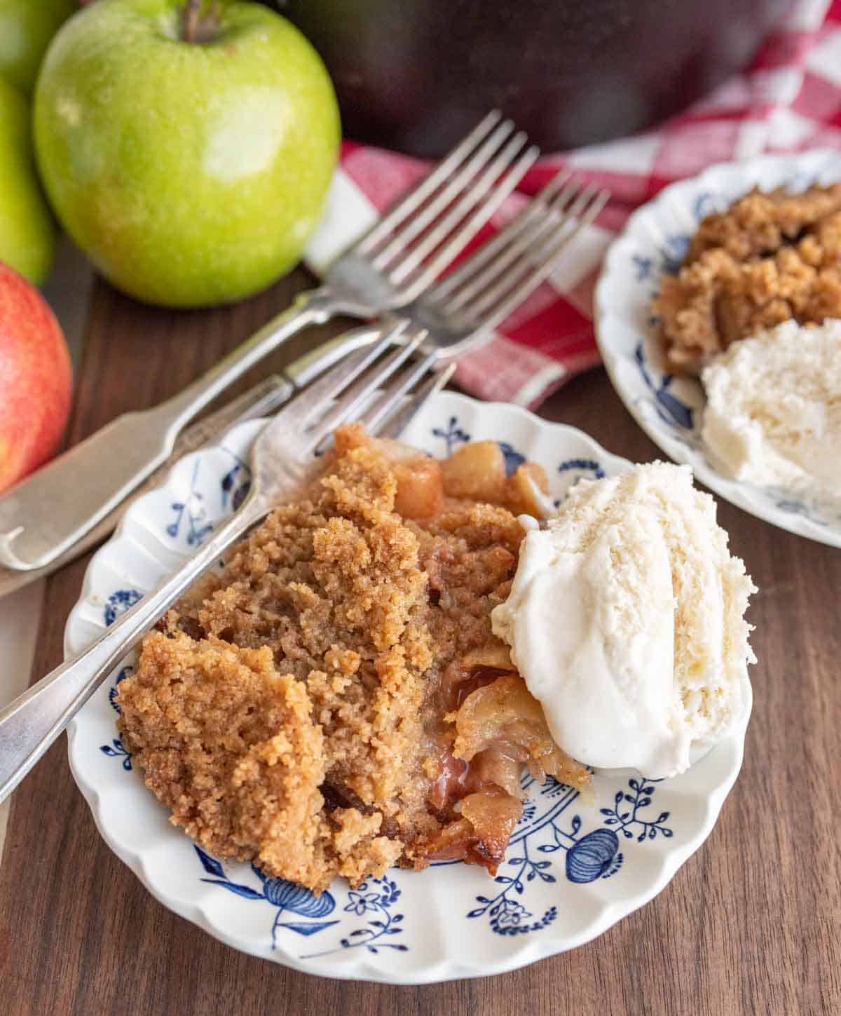 apple crumble served on a plate with ice cream