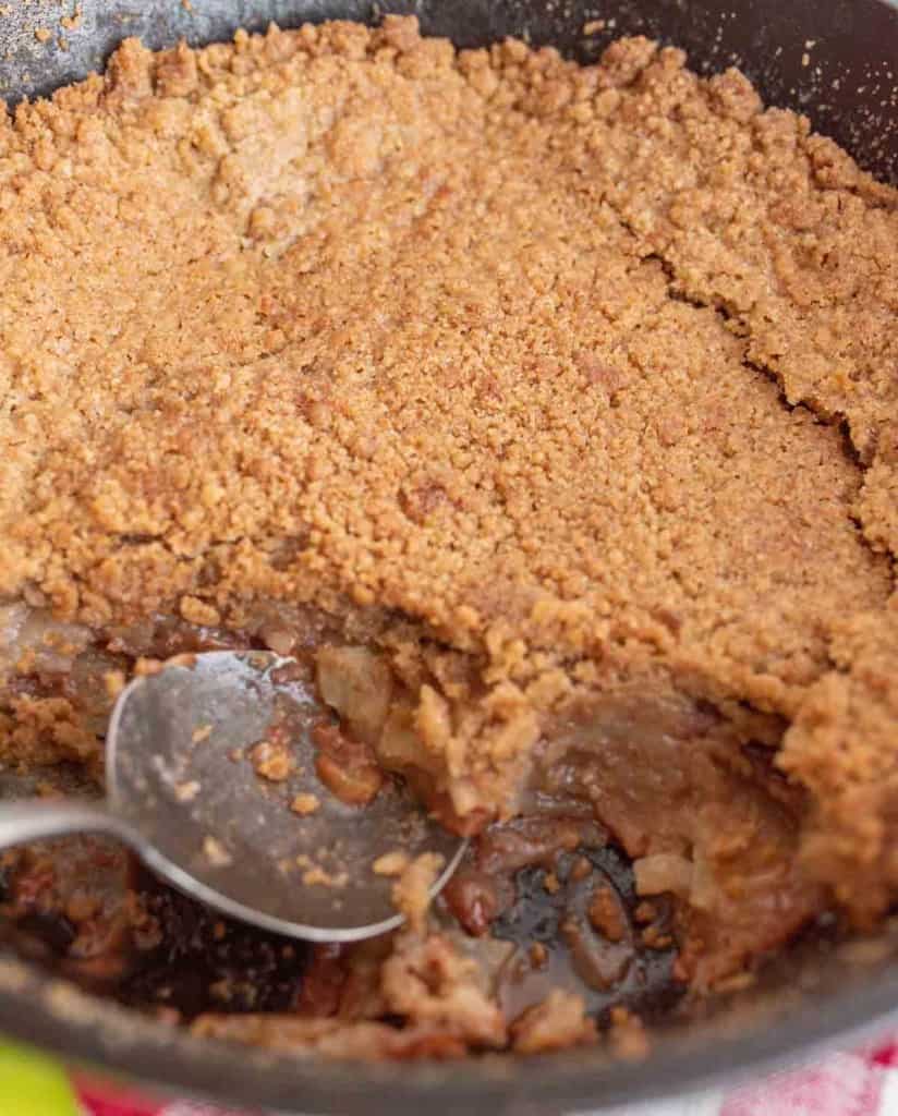 whole apple crumble in the cast iron pan
