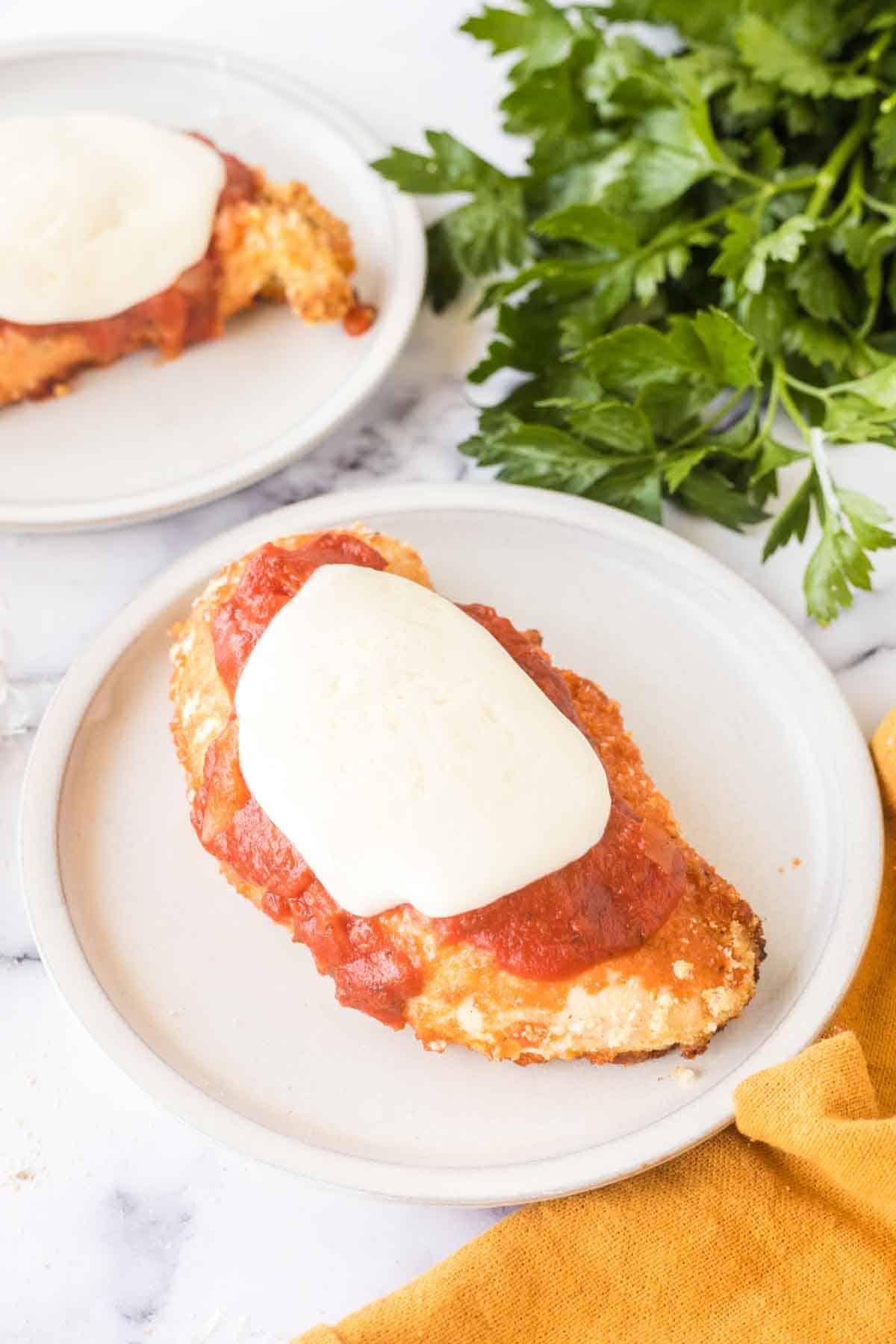 Plated baked chicken parmesan