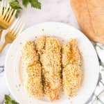 three baked chicken tenders on a white plate