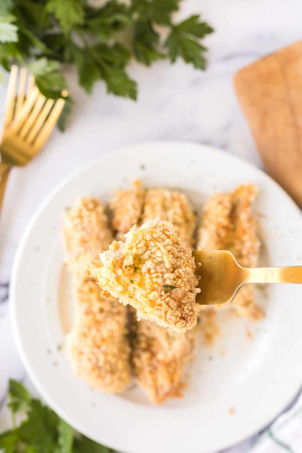 Bite of baked chicken tenders.