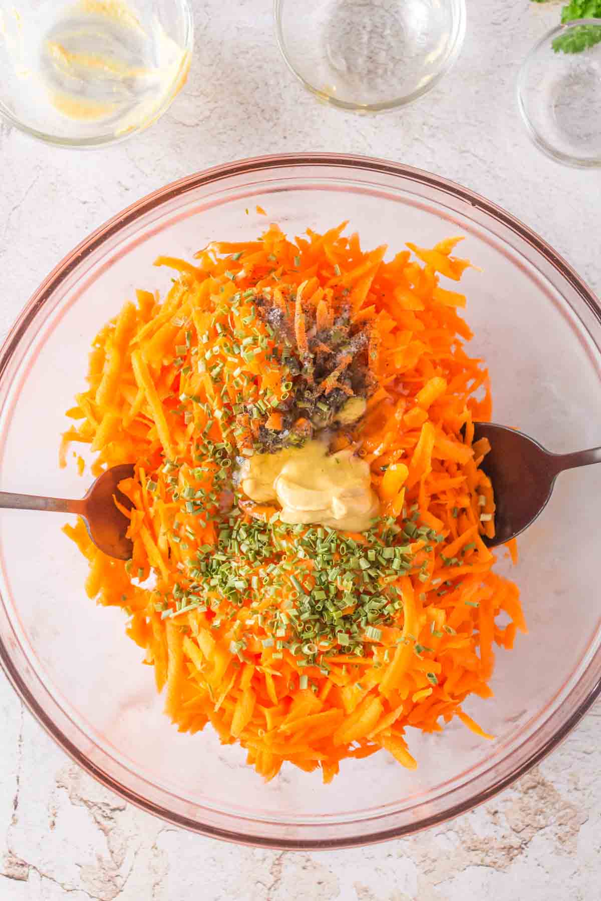 carrot salad ingredients in a mixing bowl