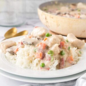 chicken ala king served onto a white plate over rice