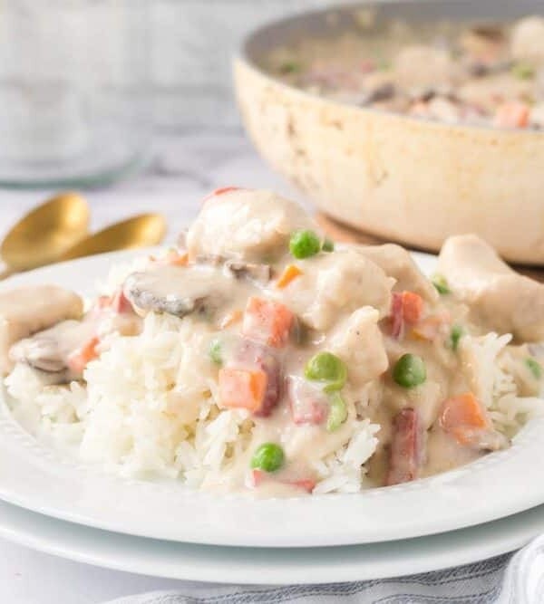 chicken ala king served onto a white plate over rice