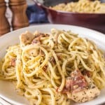 chicken carbonara with bacon and cheese on a white plate