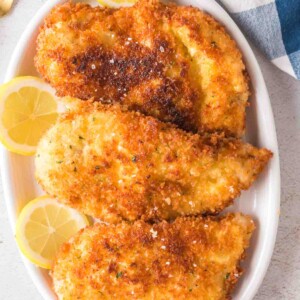 Chicken Kiev garnished with lemon slices.