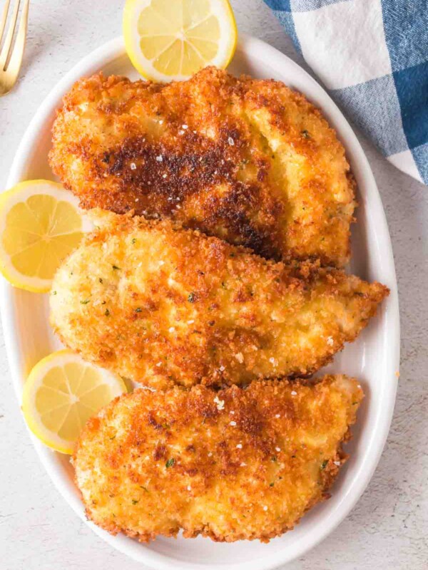 Chicken Kiev garnished with lemon slices.