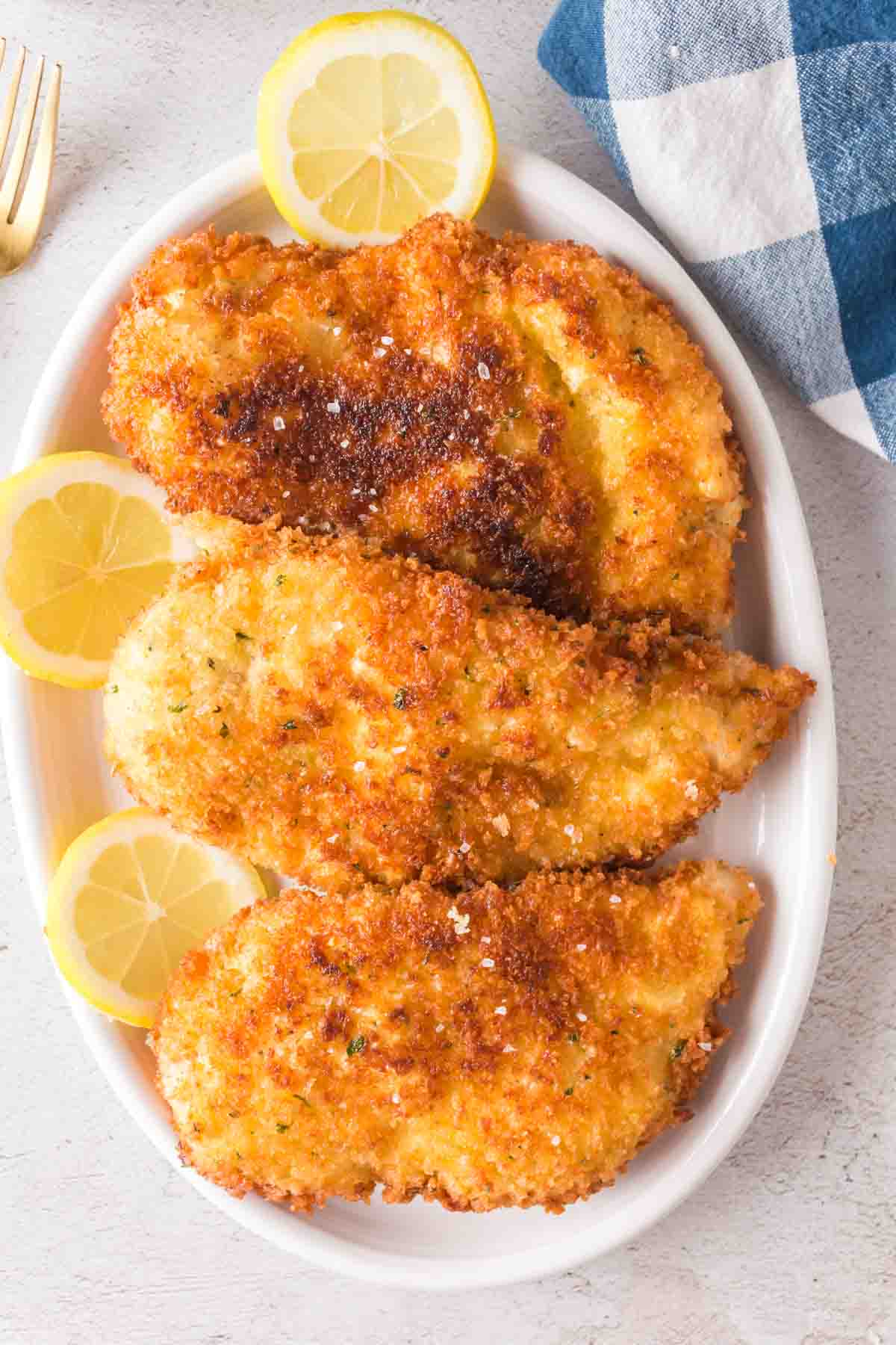 Chicken Kiev garnished with lemon slices.