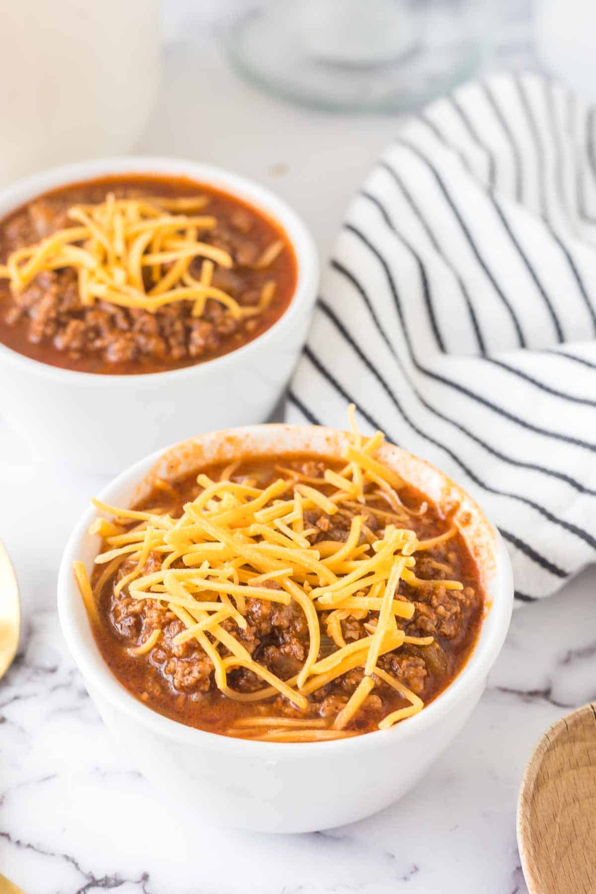 Cincinnati chili served in white bowls. 