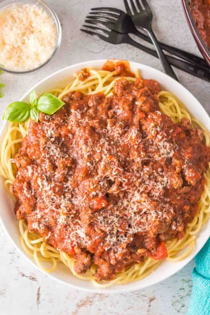top view of easy homemade spaghetti sauce on pasta on a white plate
