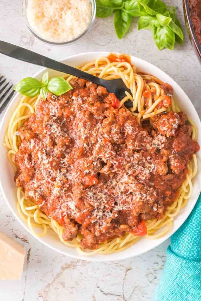 top view of easy homemade spaghetti sauce on pasta on a white plate