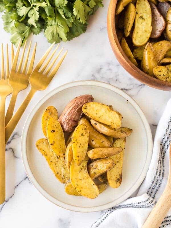 roasted fingerling potatoes on a white plate