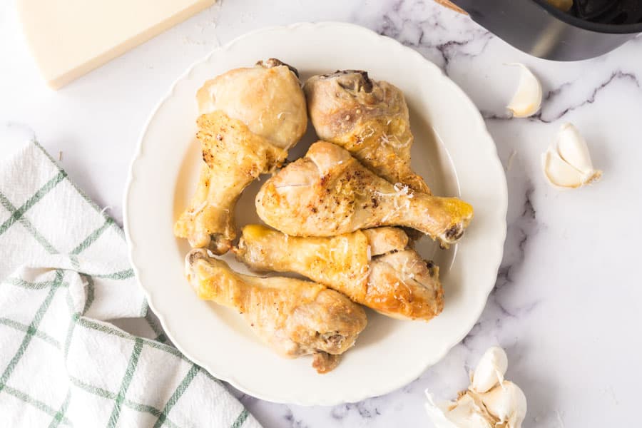 garlic parmesan air fryer chicken wings stacked on a plate