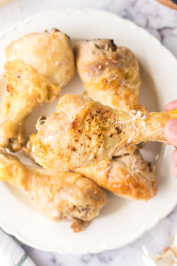 garlic parmesan air fryer chicken wings stacked on a plate