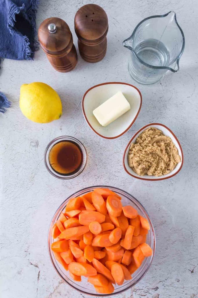 raw ingredients for glazed carrots portioned into small dishes
