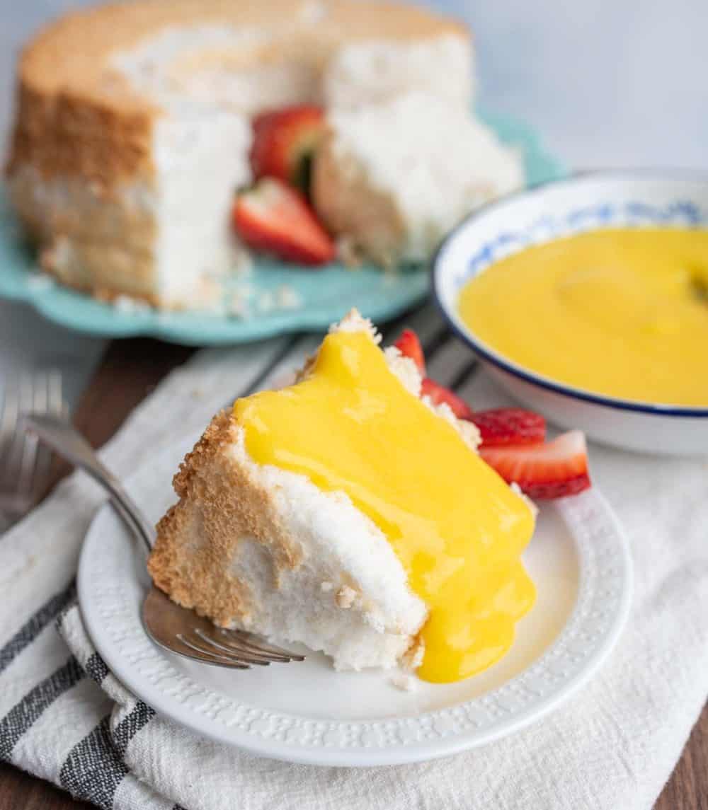 lemon curd poured over angel food cake