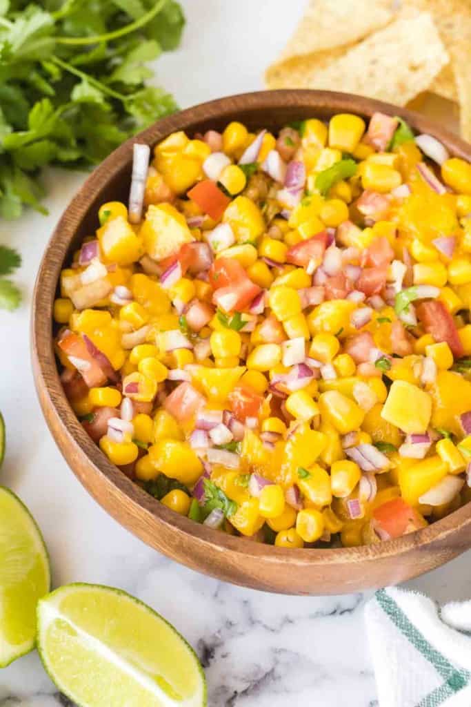 mango salsa in a wooden mixing bowl