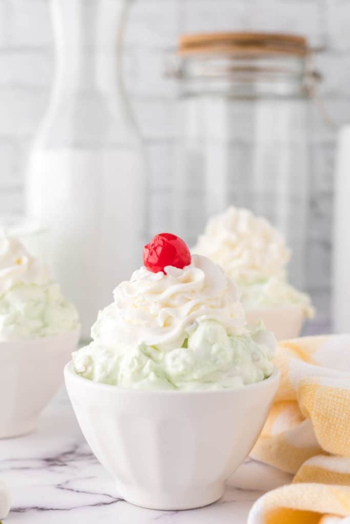 three small dishes with servings of pistachio jello salad