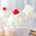 top view of pistachio jello salad topped with whipped cream and a cherry