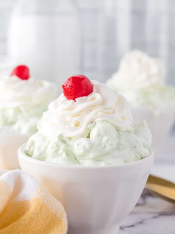 top view of pistachio jello salad topped with whipped cream and a cherry