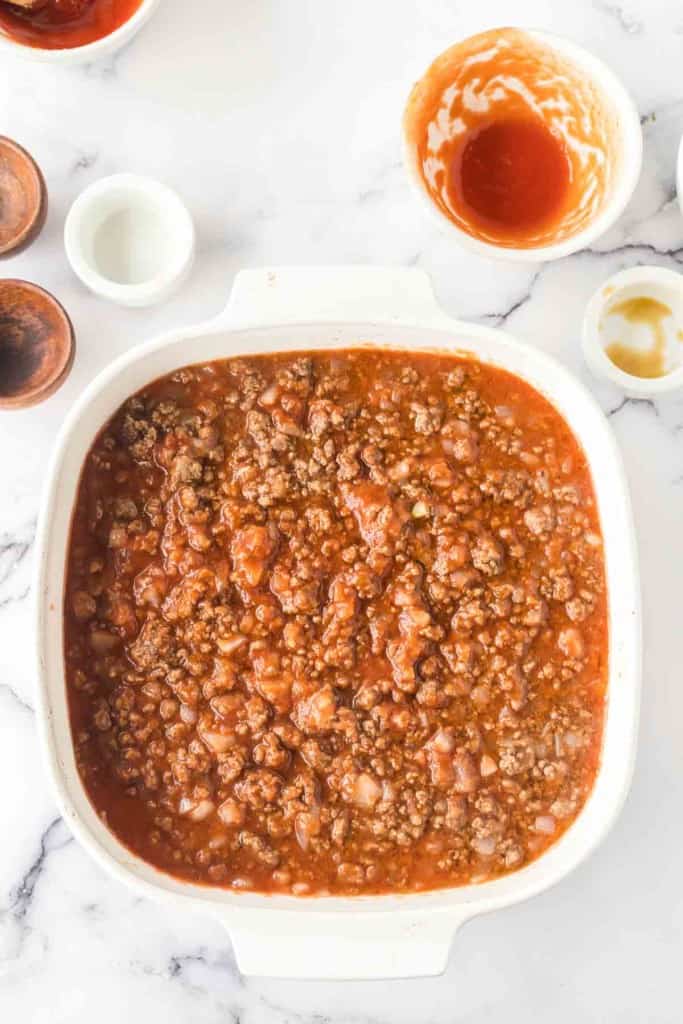 sloppy joe meat and sauce layered into a baking dish