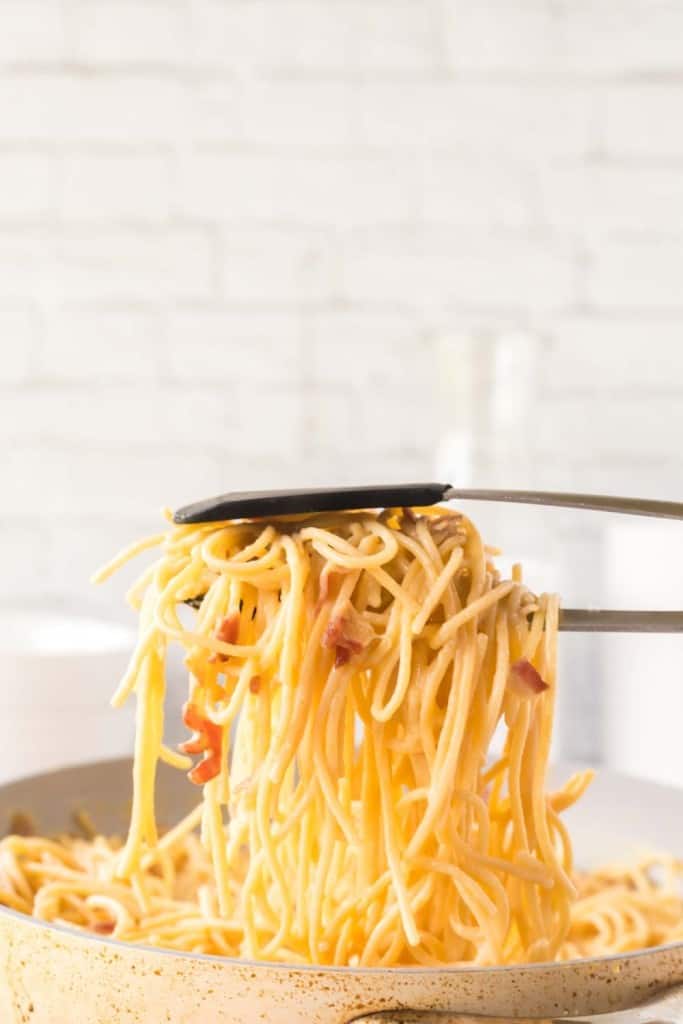 spaghetti between tongs