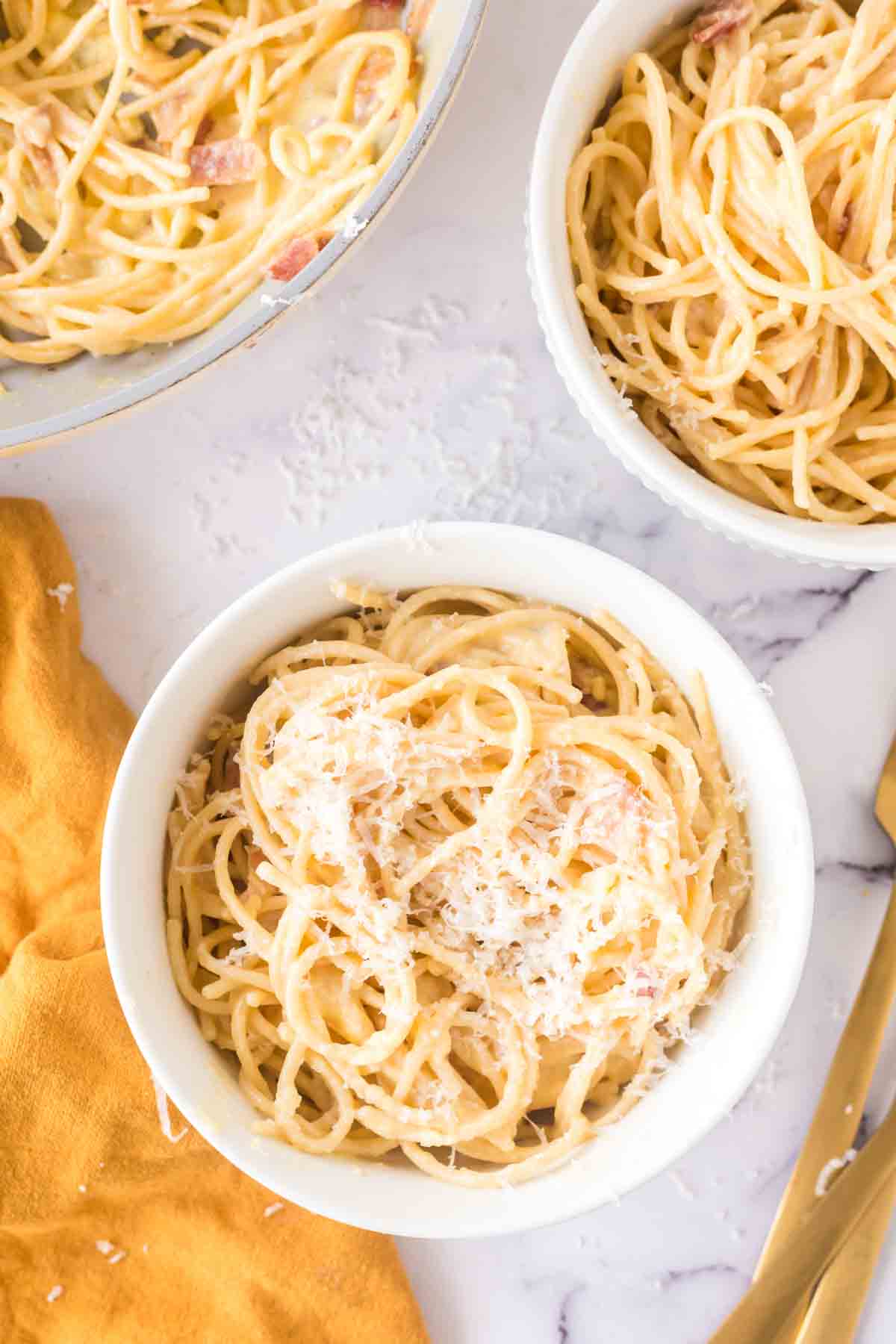 spaghetti carbonara in white bowls