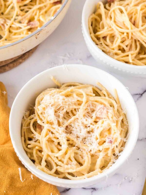 spaghetti carbonara in white bowls