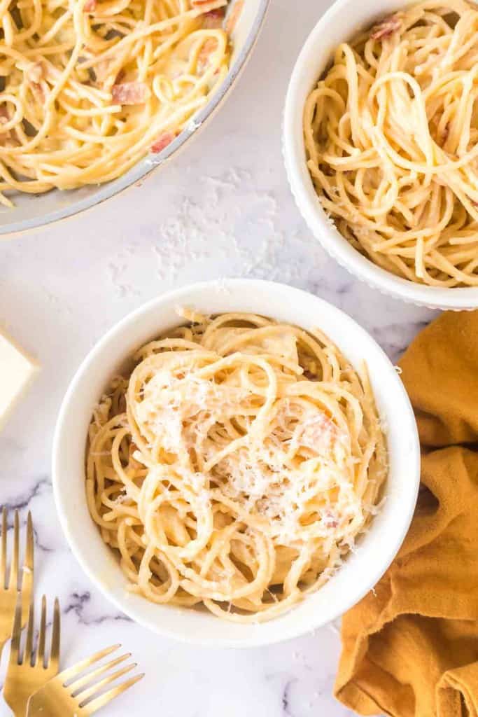 spaghetti carbonara in white bowls