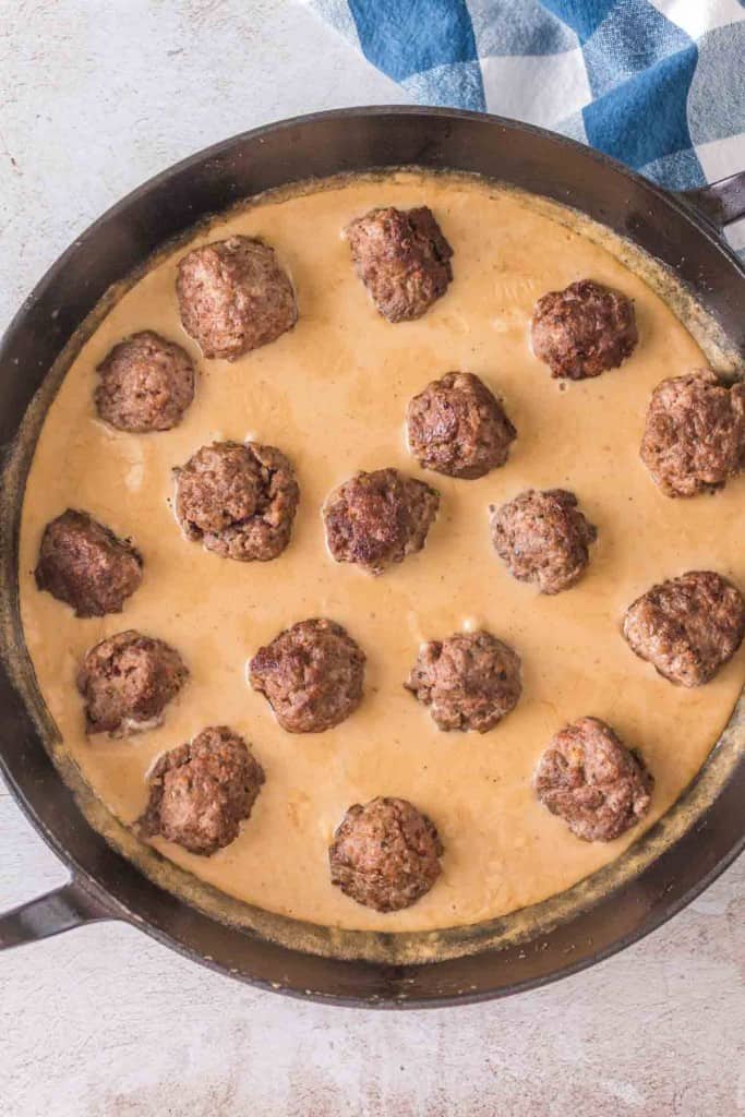 swedish meatballs in sauce in cast iron pan