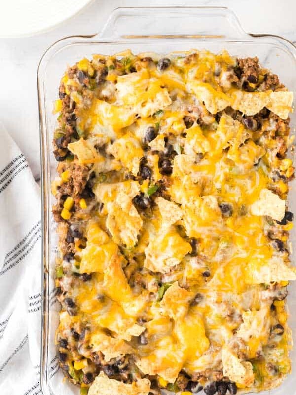 taco casserole in a clear baking dish after baked and golden melted cheese