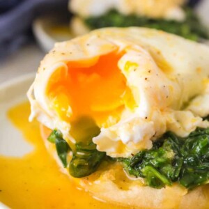 gooey poached egg atop spinach on an english muffin for eggs Florentine