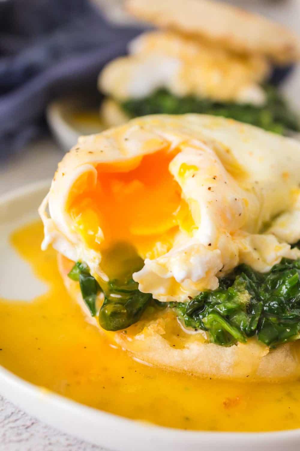 gooey poached egg atop spinach on an english muffin for eggs Florentine