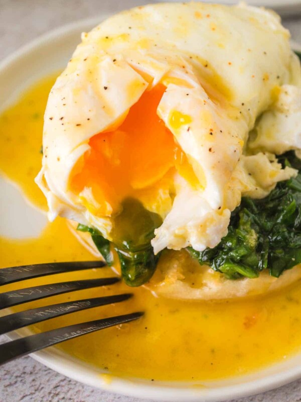 gooey poached egg atop spinach on an english muffin for eggs Florentine