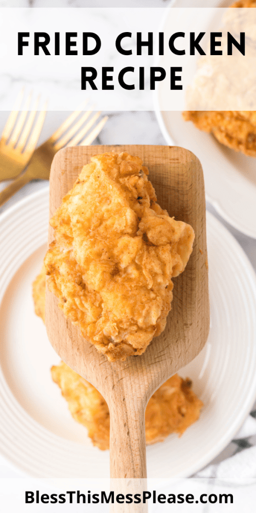 pin that reads fried chicken recipe with crispy golden chicken pieces on a wooden spatula up close