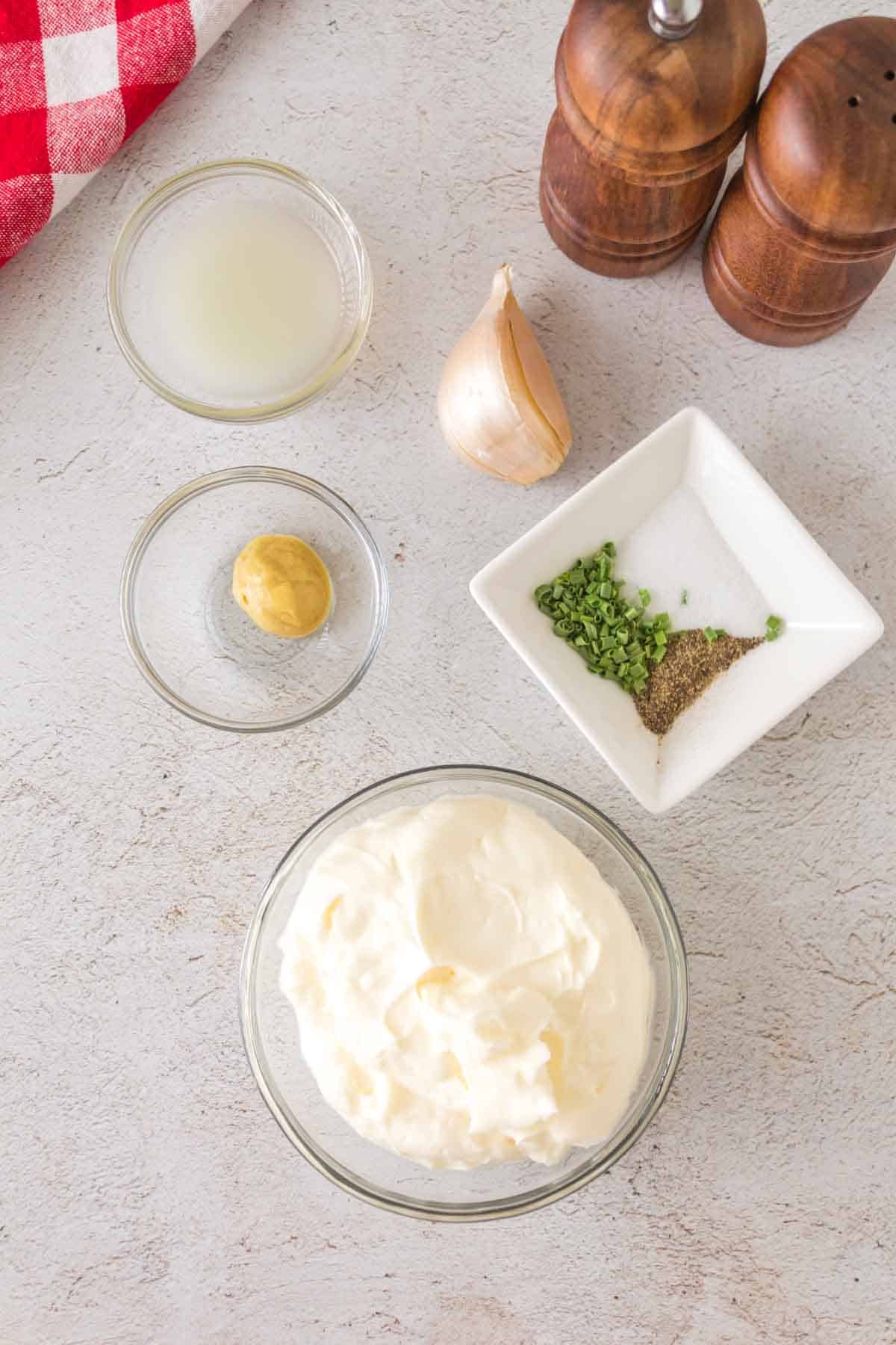 raw ingredients for homemade aioli in portioned dishes