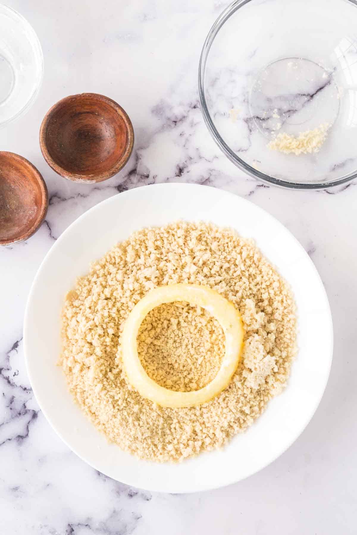 raw onion being breaded