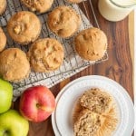 apple cinnamon muffins on a cooling rack and on a white plate