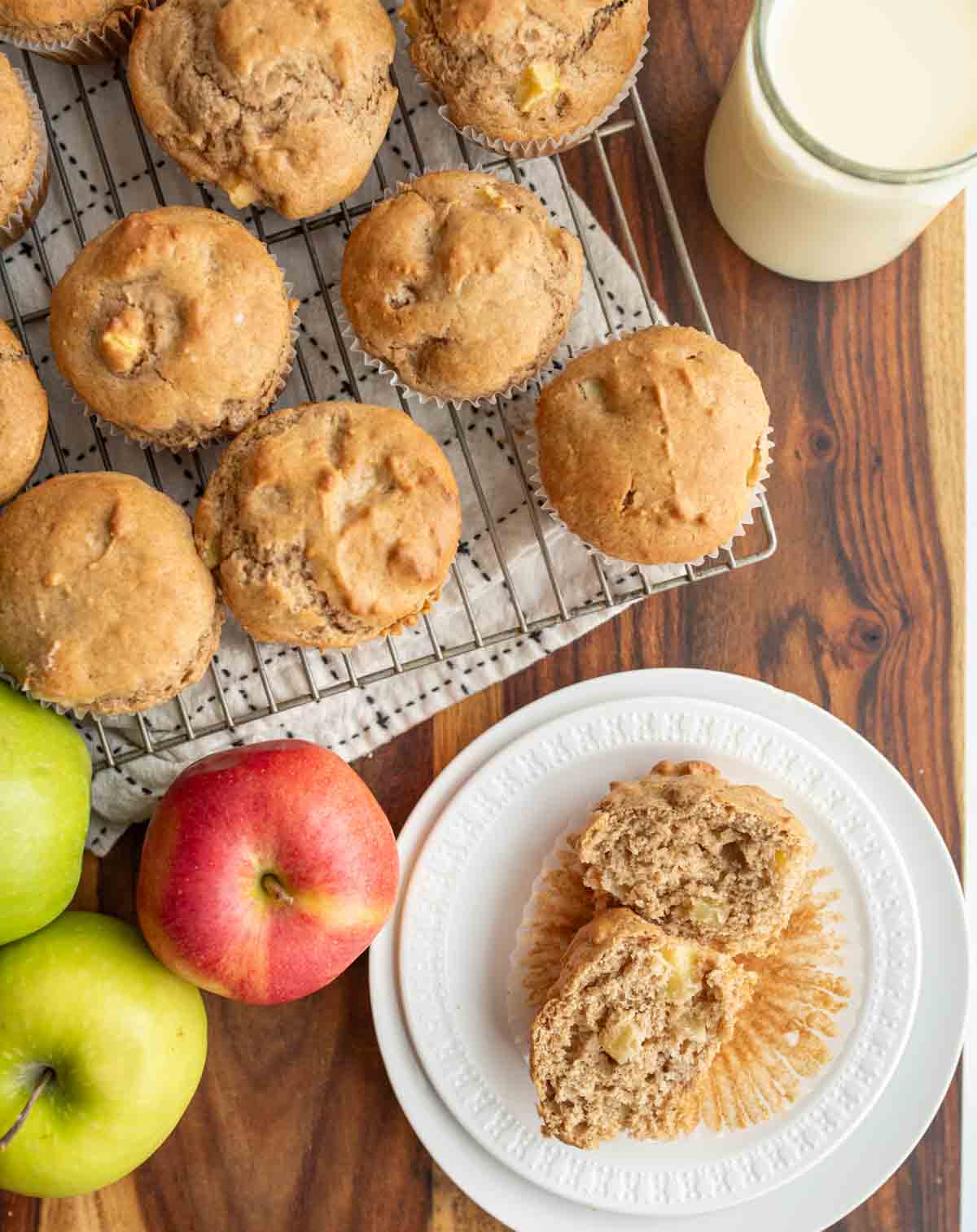 apple cinnamon muffins on a cooling rack and on a white plate
