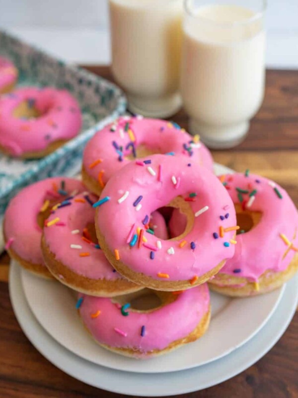 pink iced circle donuts with rainbow sprinkles