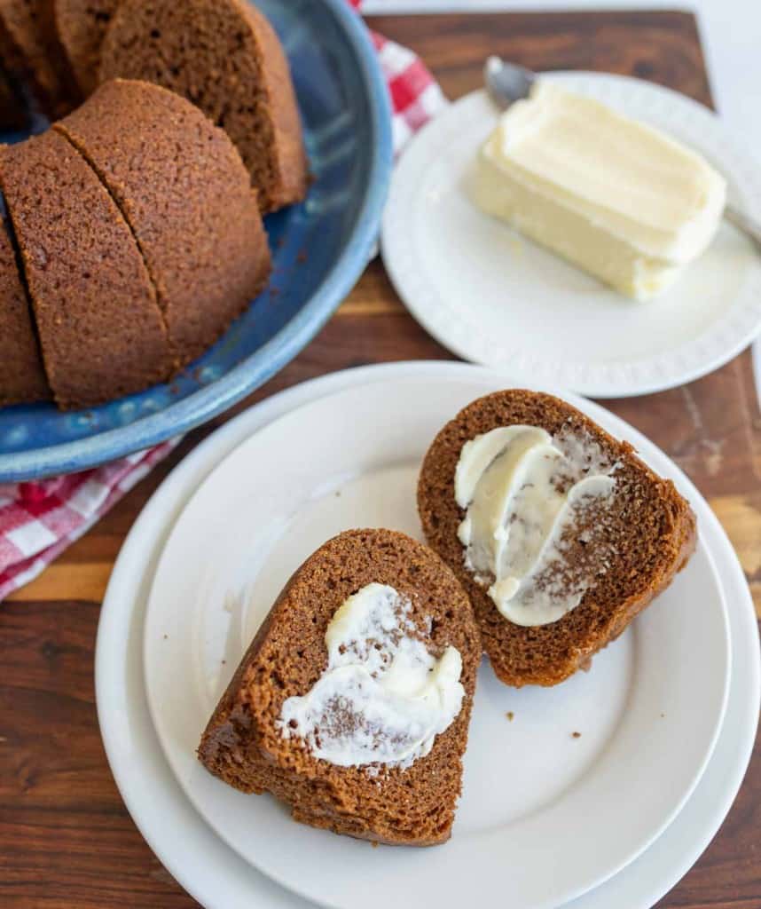 brown bread baked in a circular bundt shape sliced and buttered