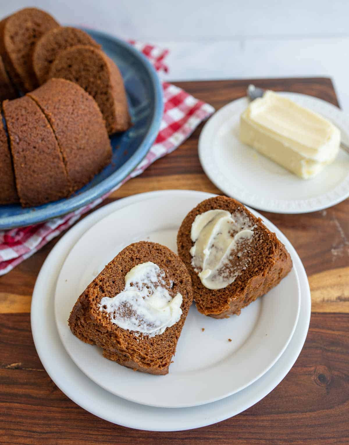 brown bread baked in a circular bundt shape sliced and buttered