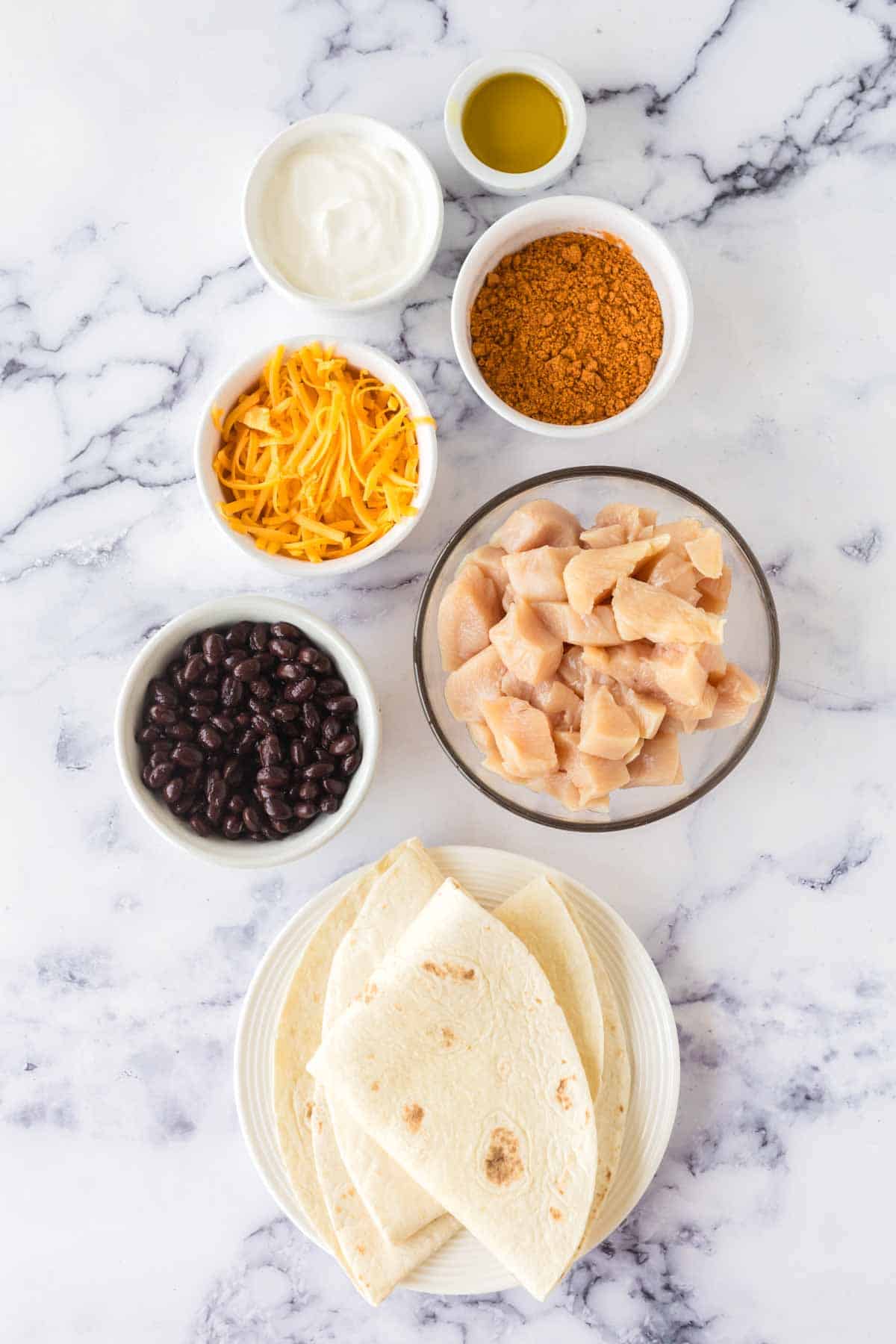 raw chicken and ingredients for chicken burritos