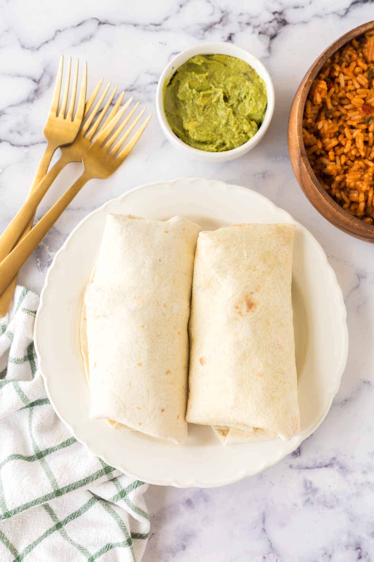 top view whole chicken burritos on a plate