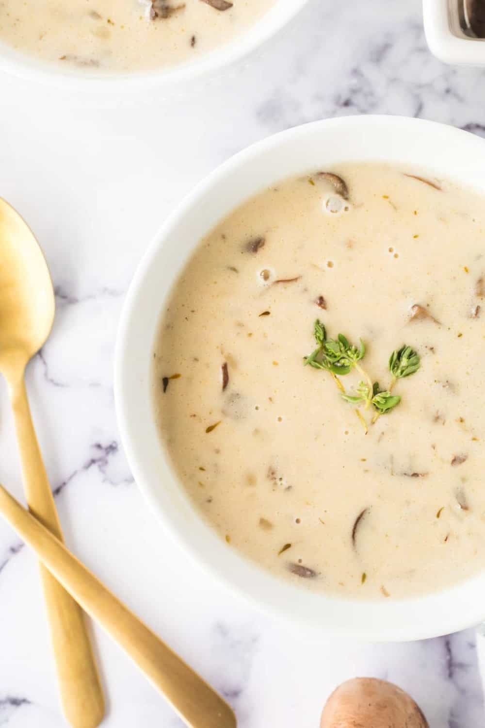 top view of creamy mushroom soup with spoons