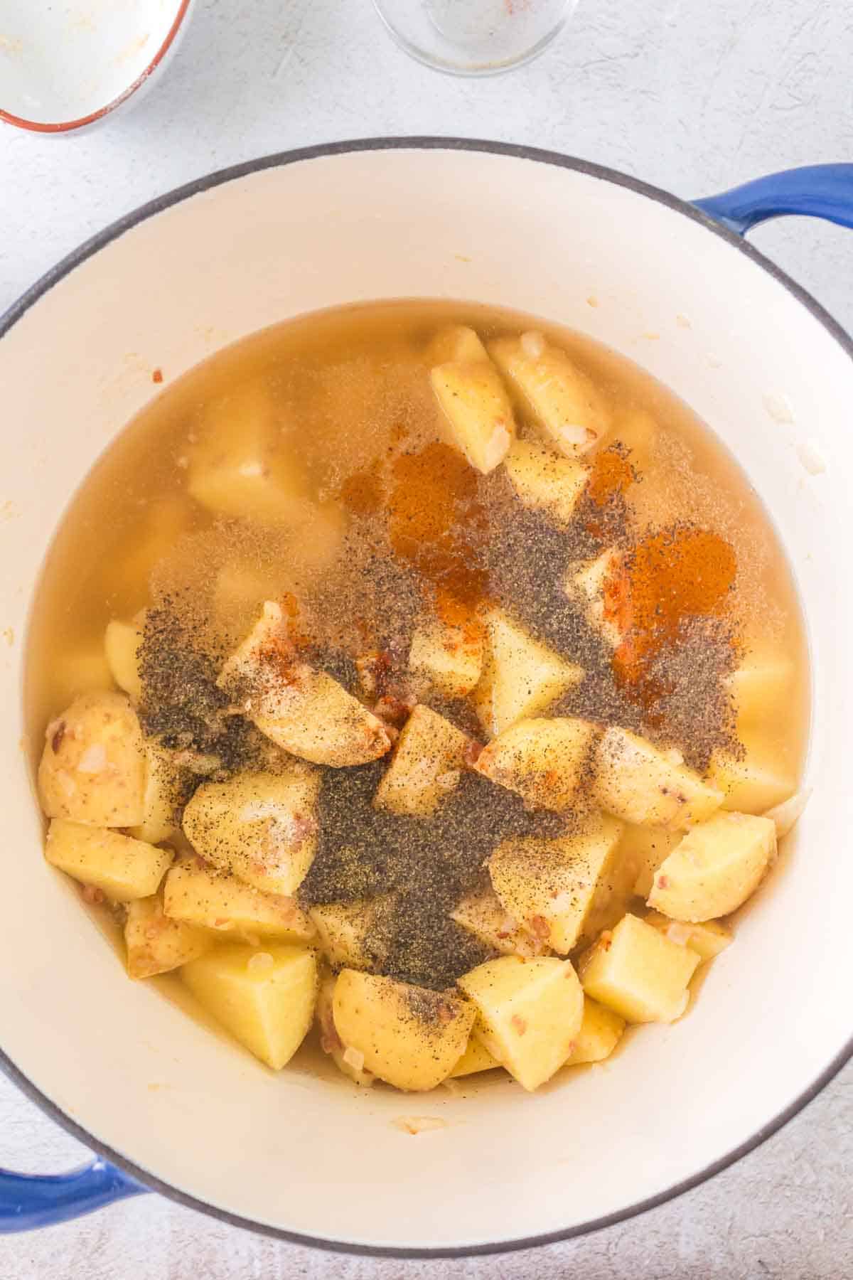 large pot of cream of potato soup ingredients before cooking down