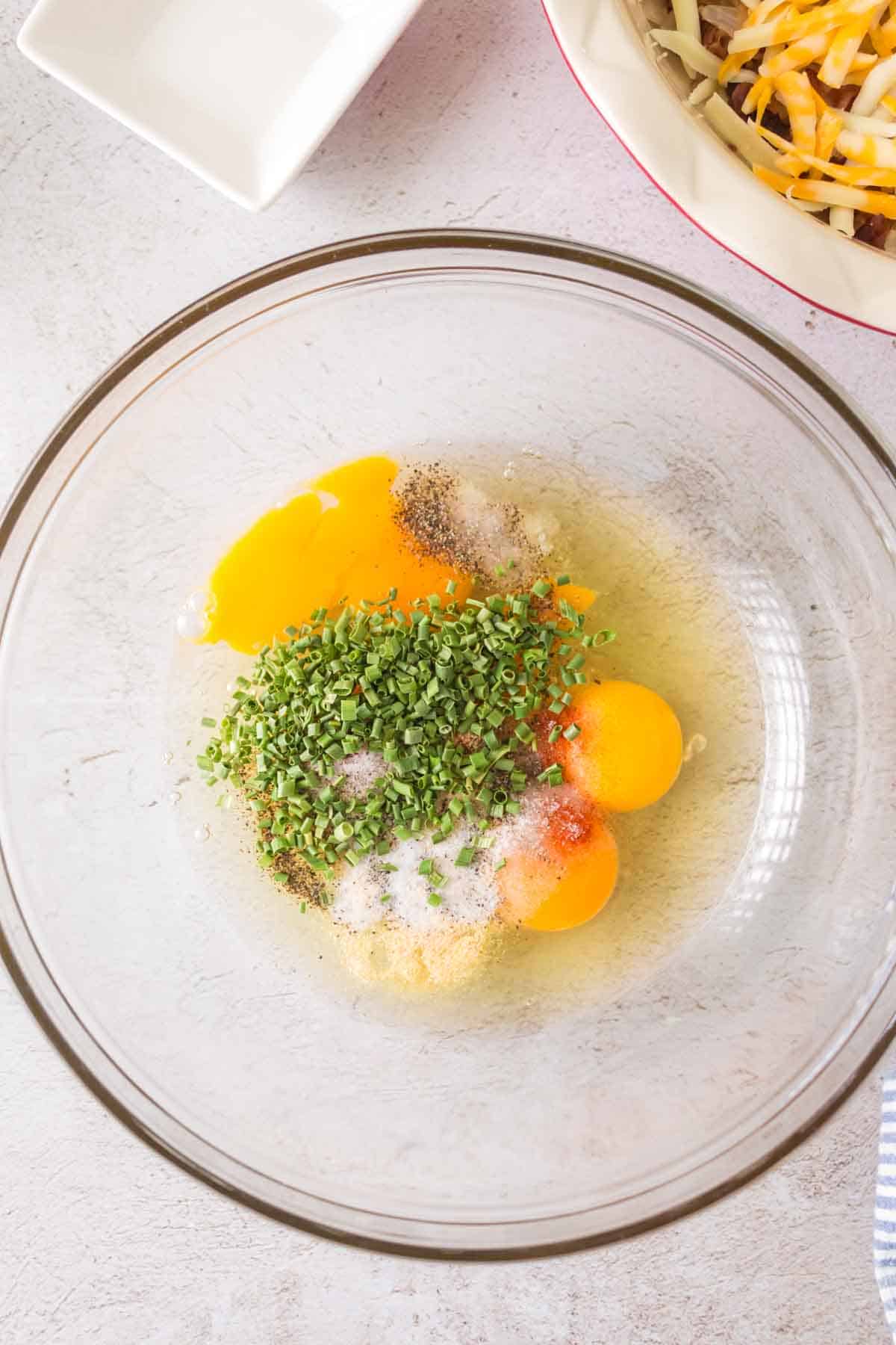 quiche ingredients in a clear mixing bowl