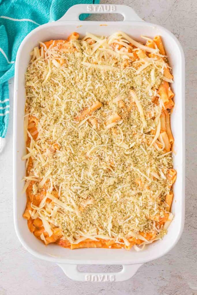 top view five cheese zita forno pasta with a creamy red sauce in a white baking dish before being baked