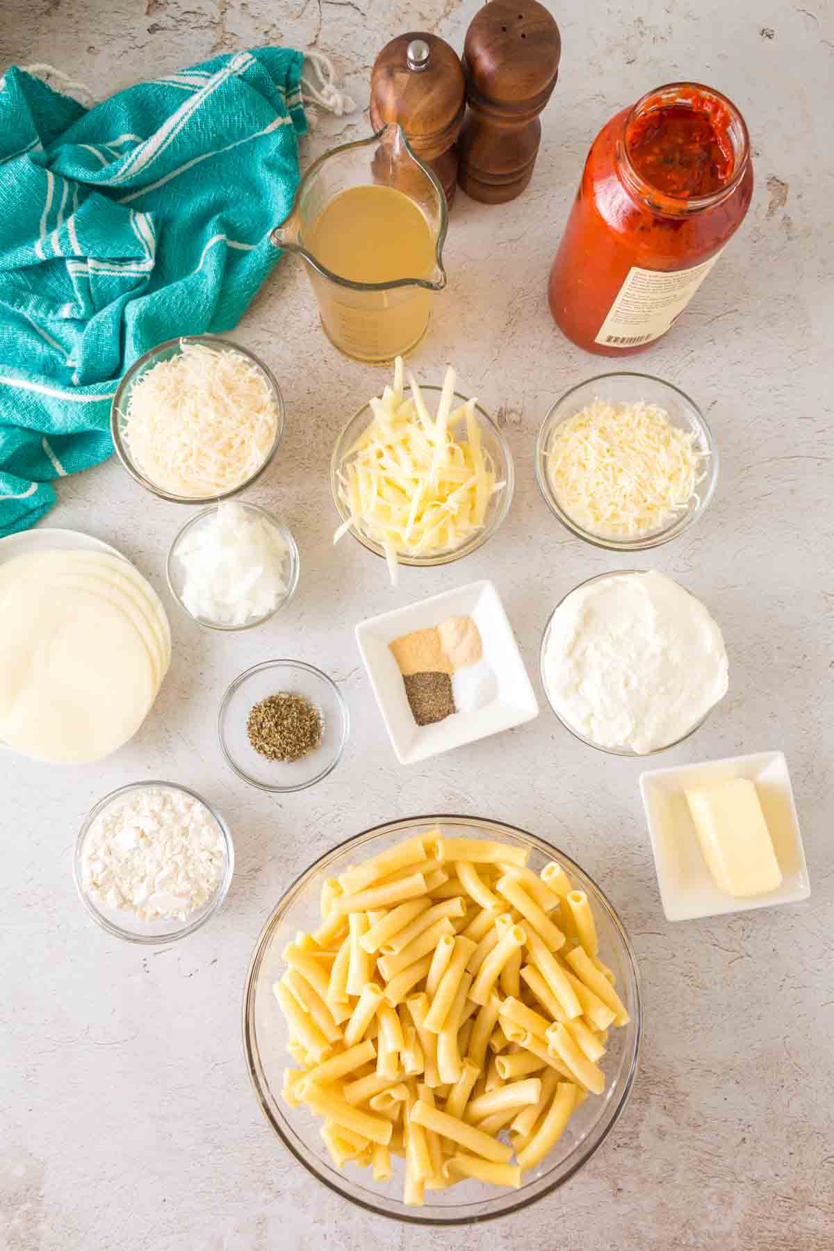 ziti al forno raw ingredients portioned on a table